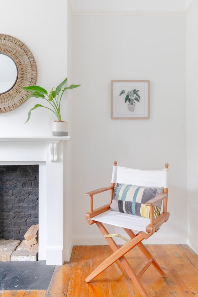 A folding, wooden armchair in the living room of a short stay holiday flat.