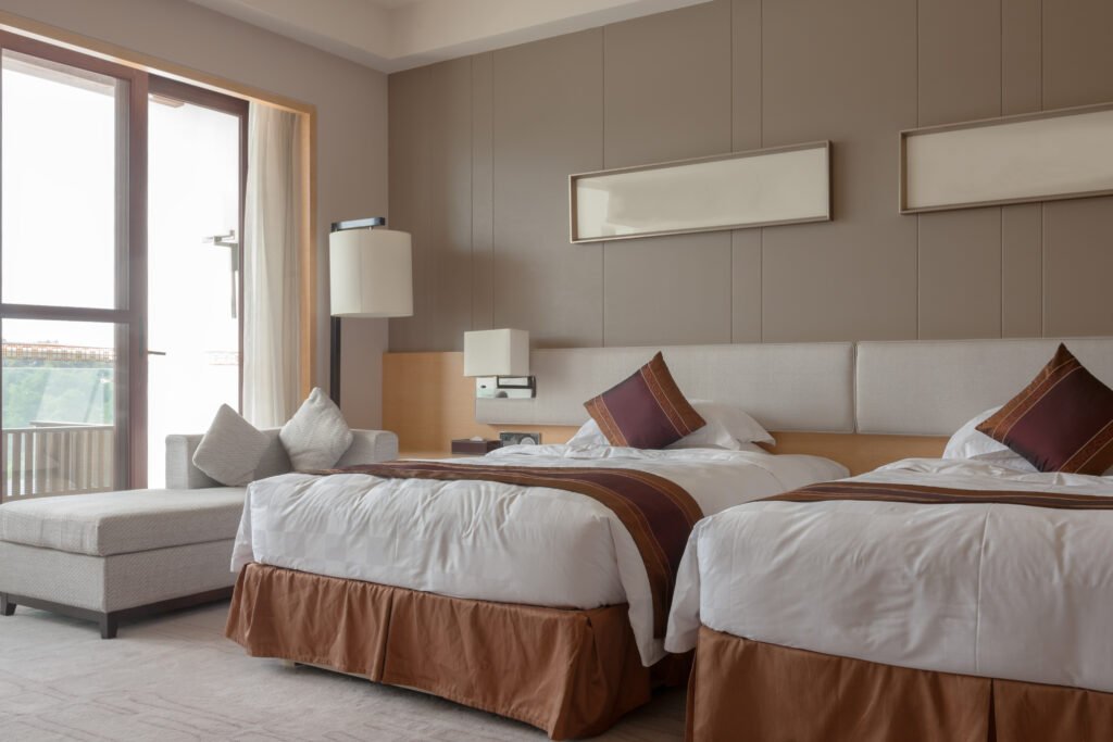 Hotel room decorated with warm colours and modern design, captured for hotel photography. 