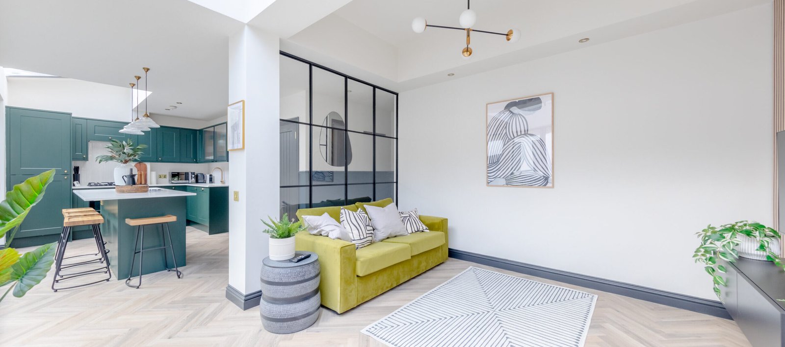 A large, spacious and modern designed reception room with open plan kitchen, captured for property photography.